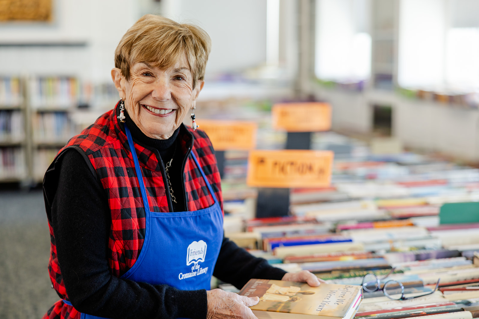 Mary Lynn, a Friend of Cromaine, arranging books for the Book Sale. 